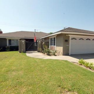 A suburban house with a neatly maintained lawn and attached garage.