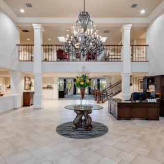 Luxurious hotel lobby with a grand chandelier and elegant reception area.