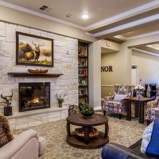 A cozy living room with a fireplace, comfortable seating, and stylish decor.