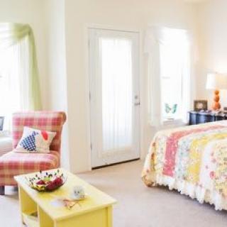A bright and cozy bedroom with colorful dcor and comfortable furnishings.