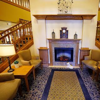 A cozy living room featuring a fireplace and comfortable seating, perfect for relaxation.