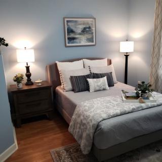 A cozy bedroom featuring soft lighting, elegant decor, and a neatly made bed.