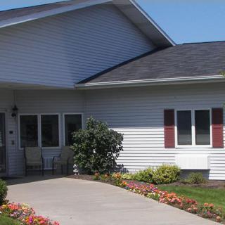 A residential house with a driveway and well-maintained garden.