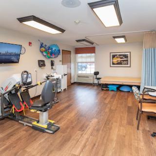 A physical therapy room equipped with exercise machines, designed for rehabilitation and recovery.