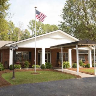 A welcoming residential building adorned with an American flag.