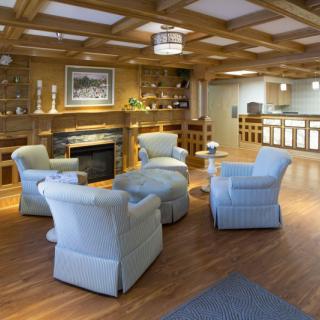 A cozy lobby seating area with comfortable chairs and a fireplace.