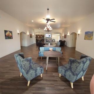 A spacious and elegantly designed living room featuring cozy seating arrangements and tasteful decor.