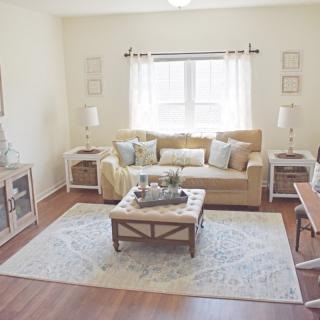 A cozy and bright living room with a neutral color palette and stylish decor.