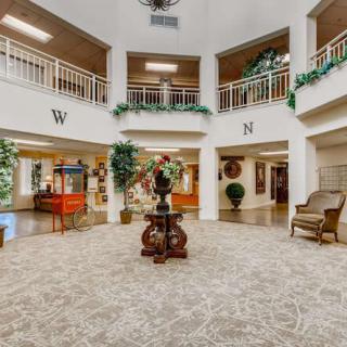 A spacious and elegantly designed lobby with decorative plants and comfortable seating.
