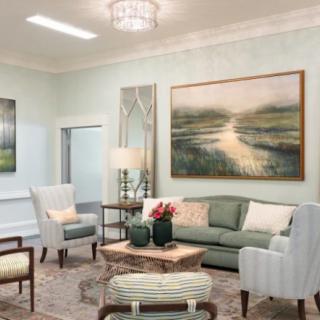 A beautifully designed living room with elegant furniture and calming artwork.