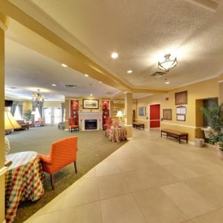 A spacious and well-decorated lobby area with seating and a fireplace.