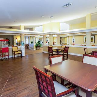 A spacious and well-lit dining area with tables and chairs arranged for comfort.