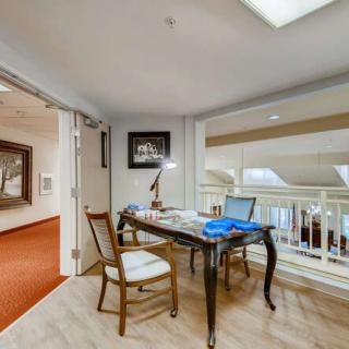 A cozy office nook with a desk, chair, and laptop, perfect for work or study.