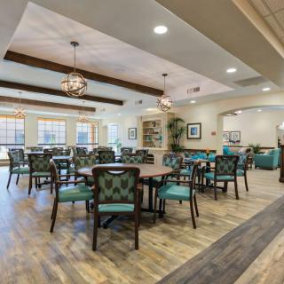 A spacious dining area with elegant furnishings and natural light.