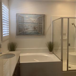 A modern bathroom with a bathtub, shower, and stylish decor.