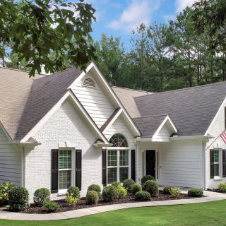 A beautiful suburban house with a well-maintained yard.