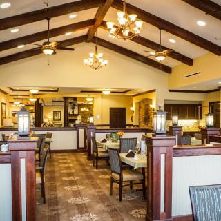 A cozy restaurant interior with elegant lighting and well-arranged seating.
