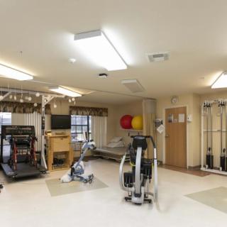 A well-equipped gym with various exercise machines and fitness equipment.