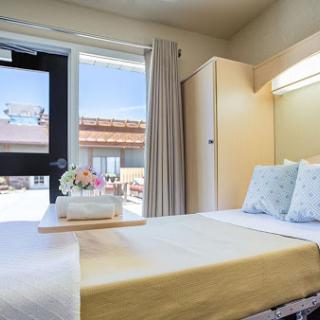 A bright and inviting bedroom with modern furnishings and a view outside.