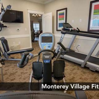 A well-equipped fitness center featuring a treadmill and exercise machines.