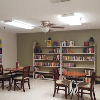 A cozy reading nook featuring bookshelves and tables for study.