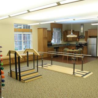 A rehabilitation space featuring exercise equipment and a modern kitchen setup.