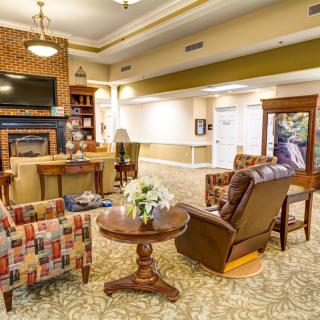 A cozy living room featuring comfortable seating, a fireplace, and stylish decor.