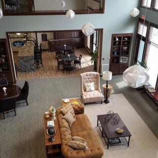 Spacious living room with a cozy seating area and large windows.