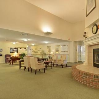 A cozy living room with comfortable seating and a brick fireplace.