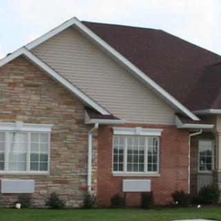 A single-story brick house with a gabled roof.