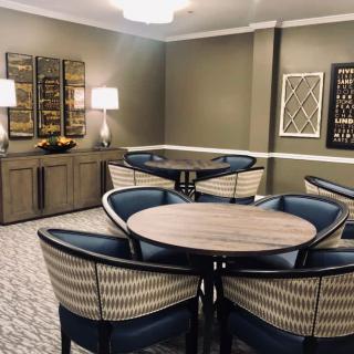 A modern dining area with stylish furniture and wall art.