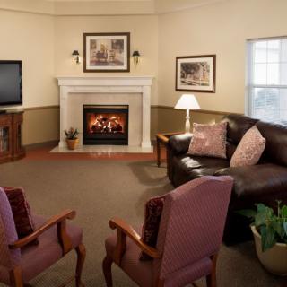 Cozy living room with a fireplace, comfortable seating, and a warm ambiance.