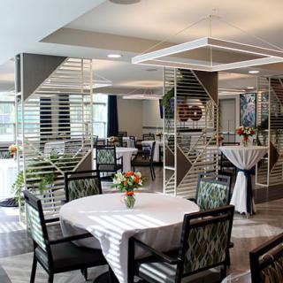 A modern dining area with elegantly set tables and contemporary decor.