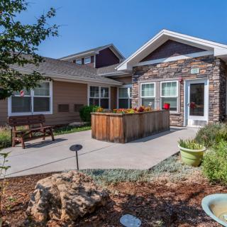 A charming house with a landscaped garden and patio area.