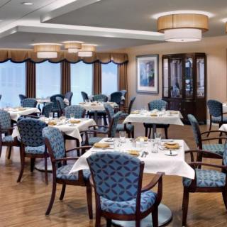 An elegant dining area with neatly arranged tables and chairs, ready for guests.