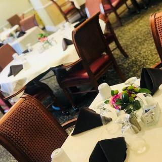 A well-arranged dining area with neatly set tables and elegant decorations.