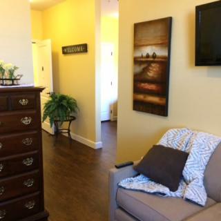A cozy living room with a comfortable armchair, TV, and decorative elements.