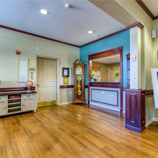 Reception area with a wooden floor and decorative elements.
