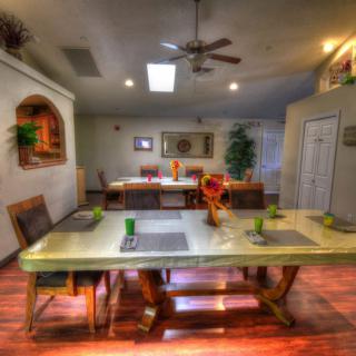 A modern dining room with a large table, chairs, and stylish decor.