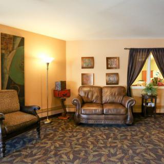 Cozy living room with leather seating and warm lighting.
