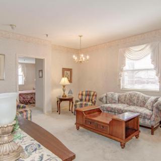 A cozy and inviting living room featuring classic furniture and soft lighting.