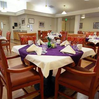 A well-set dining area with neatly arranged tables and chairs, ready for guests.