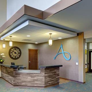 A modern reception area with a stylish desk and pendant lighting.