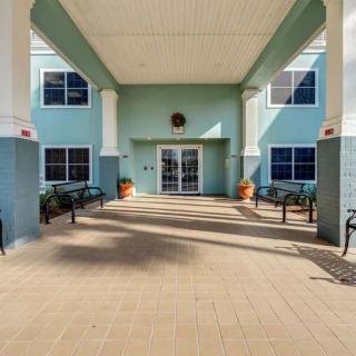 The entrance of a building with benches and columns on either side.