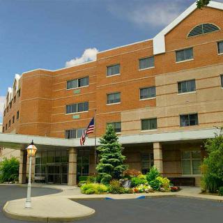 Exterior view of a hospital building with an entrance and landscaping.