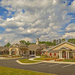 A picturesque view of a residential building under a cloudy sky.