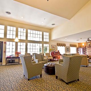 A cozy and bright lobby with comfortable seating and large windows.