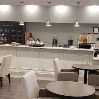 A modern cafe interior with a seating area and a counter.