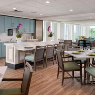 A modern dining area with neatly arranged tables and chairs, featuring a stylish interior design.