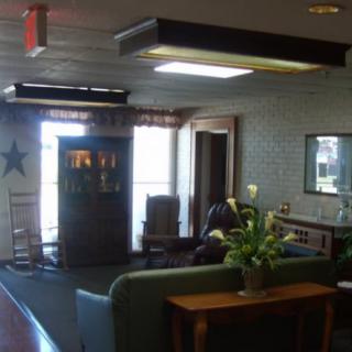 A cozy living room with comfortable seating and decorative elements.